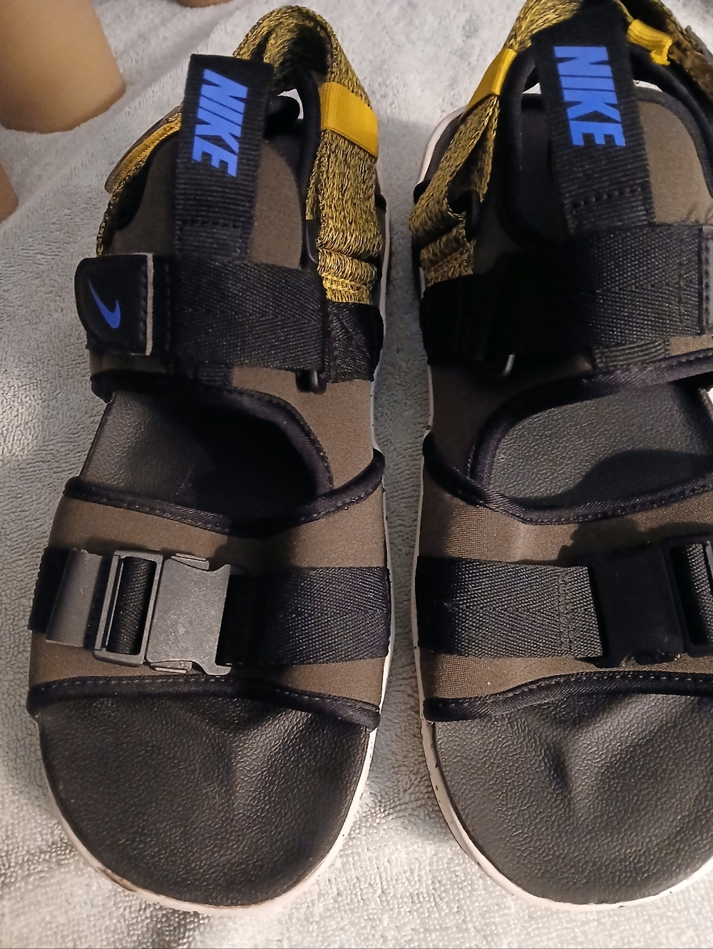 Nike Kids Black and Gold Strap Sandals with Blue Logo